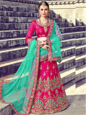 Bright And Visually Appealing Color Is Here With This Designer Lehenga Choli In Rani Pink Color Paired With Contrasting Sea Green Colored Dupatta. Its Blouse And Lehenga Are Fabricated On Art Silk Paired With Net Fabricated Dupatta. This Attractive Combination Will Earn You Lots Of Compliments From Onlookers.