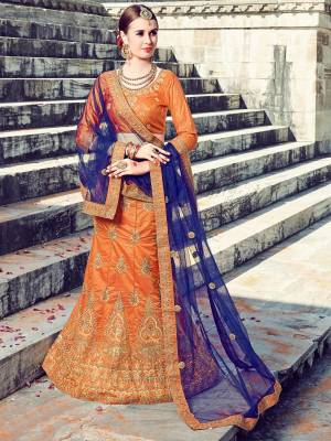 Orange Color Induces Perfect Appeal To Any Outfit So Grab This Designer Orange Colored Lehenga Choli Paired With Contrasting Navy Blue Colored Dupatta. Its Blouse And Lehenga Are Fabricated On Art Silk Paired With Net Fabricated Dupatta. Both The Fabrics Ensures Superb Comfort All Day Long.