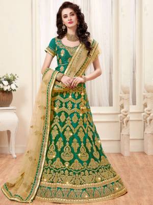 Here Is A Beautiful Designer Lehenga Choli In Green Color Paired With Beige Colored Dupatta. Its Blouse Is Fabricated On Art Silk Paired With Net Fabricated Dupatta. It Is Beautified With Heavy Jari Embroidery. Buy This Designer Lehenga Choli Now.