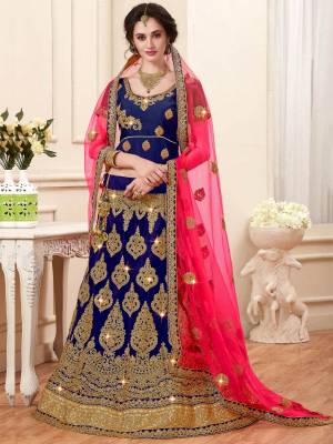 Dark Shades Always Enhance Your Beauty And Personality. So Grab This Designer Lehenga Choli In Dark Blue Color Paired With Contrasting Fuschia Pink Colored Dupatta. Its Blouse Is Fabricated On Art Silk Paired With Net Fabricated Lehenga And Dupatta. It HAs Heavy Jari Embroidery All Over It. Buy This Lehenga Choli Now.