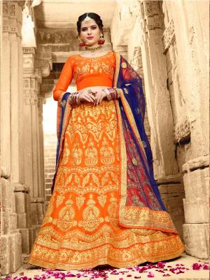 Orange Color Induces Perfect Summery Appeal To Any Outfit And Gives A Fresh Look Everytime You Wear, So Grab This Lehenga Choli In Orange Color Paired With Contrasting Navy Blue Colored Dupatta. Its Blouse Is Fabricated On Art Silk Paired With Net Fabricated Lehenga And Dupatta. Buy This Lehenga Choli Now.