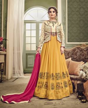 Get Ready For The Upcoming Wedding Season With This Beautiful Heavy Designer Suit In Yellow And Beige Color Paired With Yellow Colored Bottom And Contrasting Rani Pink Colored Dupatta. Its Top Is Fabricated On Georgette And Art Silk Paired With Santoon Bottom And Chiffon Dupatta. It Has Jacket Along Which Can Be Paired As Per Your Suitable Function. 