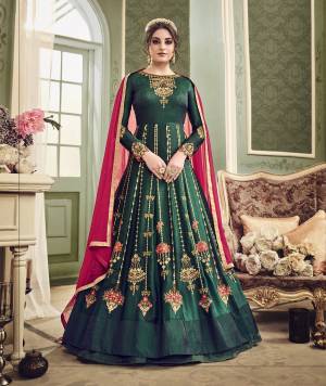 Enhance Your Beauty Wearing This Designer Floor Length Suit In Pine Green Color Paired With Pine Green Colored Bottom And Contrasting Dark Pink Colored Dupatta. Its Top Is Fabricated On Art Silk Paired With Santoon Bottom And Chiffon Dupatta. It Has Heavy Embroidery All Over The Suit Making The Suit More Attractive. Buy Now.