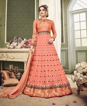 Shine Bright Wearing This Designer Floor Length Suit In Light Orange Color Paired With Light Orange Colored Bottom And Dupatta. Its Top Is Fabricated On Net Paired With Santoon Bottom And Chiffon Dupatta. It Has Detailed Embroidery All Over The Top. This Suit Also Ensures Superb Comfort All Day Long. 