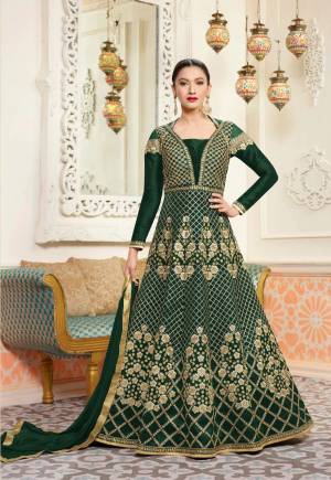 Add This New Dark Shade To Your Wardrobe With This Designer Floor Length Suit In Pine Green Colored Top Paired With Pine Green Colored Bottom And Dupatta. Its Top Is Fabricated On Art Silk Paired With Santoon Bottom And Chiffon Dupatta. It Has Embroidery All Over Making The Suit More Attractive. Buy Now.