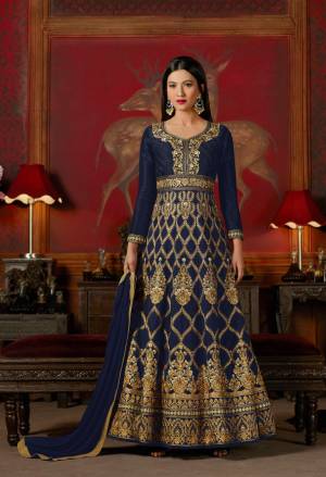 Have A Bold And Beautiful Personality Wearing This Designer Floor Length Suit In Navy Blue Color Paired With Navy Blue Colored Bottom And Dupatta. Its Top Is Fabricated On Art Silk Paired With Santoon Bottom And Chiffon Dupatta. Its Top Has Heavy Embroidery All Over It, Which Will Earn You Lots Of Compliments From Onlookers.
