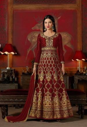 Be The Royal One Wearing This Designer Floor Length Suit In Maroon Color Paired With Maroon Colored Bottom And Dupatta. Its Top Is Fabricated