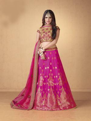Bright And Visually Appealing Color Is Here With Designer Lehenga Choli In Beige Colored Blouse, Paired With Rani Pink Colored Lehenga And Dupatta. Its Blouse And Lehenga Are Fabricated On Art Silk Paired With Net Fabricated Dupatta. It Is Light Weight And Easy To Carry Throughout The Gala.