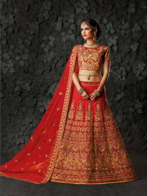 Here Is A Beautiful Designer Lehenga Choli In Beige Colored Blouse Paired With Red Colored Lehenga And Dupatta. Its Blouse And Lehenga Are Fabricated On Art silk Paired With Net Fabricated Dupatta. This Lehenga Choli Is Beautified With Heavy Embroidery All Over It. Buy It Now.