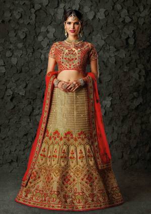 Grab This Beautiful Designer Heavy Lehenga Choli In Red Colored Blouse Paired With Beige Colored Lehenga And Red Colored Dupatta. Its Blouse and Lehenga Are Fabricated On Art Silk Paired With Net Fabricated Dupatta. It Has Heavy Embroidery All Over The Attire. Buy Now.
