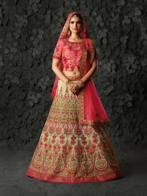 Add This Lovely Designer Lehenga Choli To Your Wardrobe In Dark Pink Colored Blouse Paired With Beige Colored Lehenga And Dark Pink Colored Dupatta. It Is Beautified With Heavy Embroidery All Over. Buy Now.
