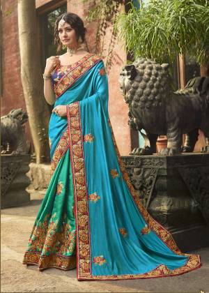 Here Is A Very Pretty Saree In Cool Color Pallet With This Designer Saree In Blue And Sea Green Color Paired With Contrasting Navy Blue Colored Blouse. This Saree And Blouse are Fabricated On Art Silk Beautified With Jari And Thread Embroidery With Stone Work. Buy Now.