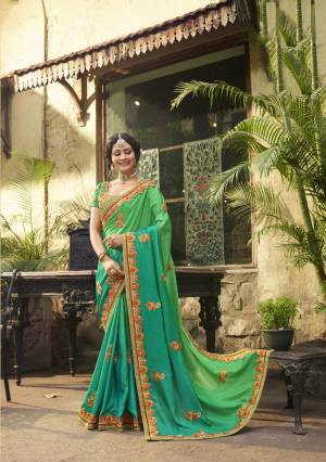 Here Is A Very Pretty Saree In Cool Color Pallet With This Designer Saree In Green And Turquoise Blue Color Paired With Green Colored Blouse. This Saree And Blouse are Fabricated On Art Silk Beautified With Jari And Thread Embroidery With Stone Work. Buy Now.