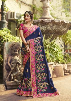 Enhance Your Personality Wearing This Designer Saree In Navy Blue Color Paired With Contrasting Dark Pink Colored Blouse. This Saree And Blouse Are Fabricated On Art Silk Beautified With Heavy Embroidery Making The Saree More Attractive. Buy Now.
