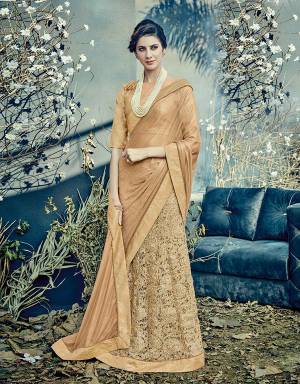 Exude an old world charm in this beige Colored lehenga saree . Add pearls to this outfit for that perfect vintage appeal. 
