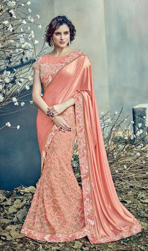 Showcase your exquisite taste in this pretty Peach Colored lehenga saree adorned with beuatifully ornamented fabrics and look mesmerizing. 