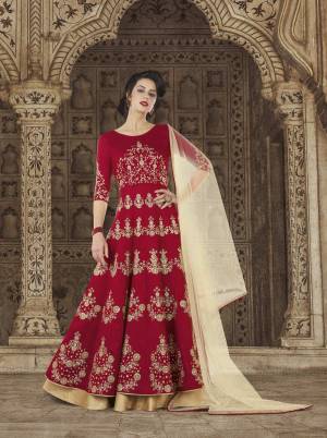Here Is A Royal Looking Designer Floor Length Suit In Maroon Color Paired With Maroon Colored Bottom And Beige Colored Dupatta. Its Top Is Fabricated On Art Silk Paired With Santoon Bottom And Net Dupatta. It Is Also Comfortable To Wear Throughout The Gala.