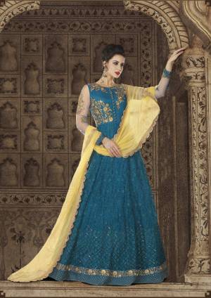 Another Beautiful Designer Floor Length Suit Is Here In Blue Color Paired With Blue Colored Bottom And Contrasting Yellow Colored Dupatta. Its To[ Is Fabricated On Net Paired With Sanrtoon Bottom And Net Dupatta. It Is Light Weight And Easy To Carry Throughout The Gala.