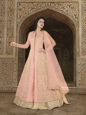 This Season Is About Subtle Shades And Pastel Play, So Grab This Designer Indo-Western Suit In Pastel Pink Colored Paired With Beige Colored Lehenga And Pastel Pink Dupatta. Its Top Is Fabricated On Art Silk Paired With Jacquard Silk Lehenga And Net Dupatta. This Pretty Suit Will Earn You Lots Of Compliments From Onlookers.