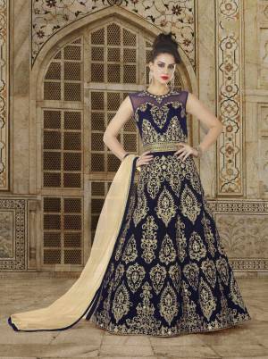 Enhance Your Beauty In This Designer Floor Length Suit In Navy Blue Color Paired With Navy Blue Colored Bottom And Beige Colored Dupatta. Its Top IS Fabricated On Velvet Paired With Santoon Bottom And Net Dupatta. Buy This Designer suit Now.