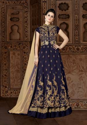 Adorn The Lovely Queen Look Wearing This Designer Floor Length Suit In Navy Blue Color Paired With Beige Colored Lehenga And Dupatta. Its Top Is Fabricated On Art Silk Paired With Net And Santoon Fabricated Lehenga And Net Fabricated Dupatta. This Designer Indo-Western Dress Will Give Your Personality An Attractive Look. Buy Now.