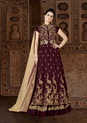 Adorn The Lovely Queen Look Wearing This Designer Floor Length Suit In Wine Color Paired With Beige Colored Lehenga And Dupatta. Its Top Is Fabricated On Art Silk Paired With Net And Santoon Fabricated Lehenga And Net Fabricated Dupatta. This Designer Indo-Western Dress Will Give Your Personality An Attractive Look. Buy Now.