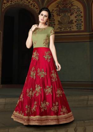 Grab This Beautiful Designer Yoke Patterned Floor Length Suit In Red And Green Color Paired With Green Colored Bottom And Dupatta. Its Top Is Fabricated On Art Silk Paired With Santoon Bottom And Net Dupatta. It Is Beautified With Cut Work Embroidery In Patches. Buy It Now.