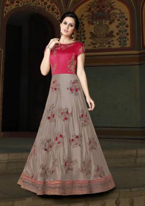 Grab This Beautiful Designer Yoke Patterned Floor Length Suit In Grey And Pink Color Paired With Pink Colored Bottom And Dupatta. Its Top Is Fabricated On Art Silk Paired With Santoon Bottom And Net Dupatta. It Is Beautified With Cut Work Embroidery In Patches. Buy It Now.