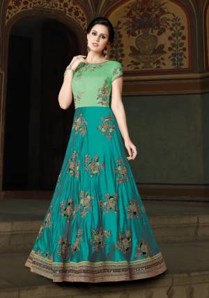 Grab This Beautiful Designer Yoke Patterned Floor Length Suit In Turquoise Blue And Sea Green Color Paired With Sea Green Colored Bottom And Dupatta. Its Top Is Fabricated On Art Silk Paired With Santoon Bottom And Net Dupatta. It Is Beautified With Cut Work Embroidery In Patches. Buy It Now.