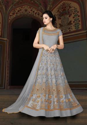 Flaunt Your Rich And Elegant Taste Wearing This Designer Floor Length Suit In Grey Color Paired With Grey Colored Bottom And Dupatta. Its Top Is Fabricated On Net Paired With Santoon Bottom And Chiffon Dupatta. Its Beautiful Yoke Pattern Will Earn You Lots Of Compliments From Onlookers.