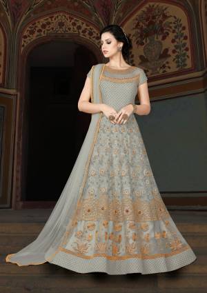 Flaunt Your Rich And Elegant Taste Wearing This Designer Floor Length Suit In Pale Grey Color Paired With Pale Grey Colored Bottom And Dupatta. Its Top Is Fabricated On Net Paired With Santoon Bottom And Chiffon Dupatta. Its Beautiful Yoke Pattern Will Earn You Lots Of Compliments From Onlookers.