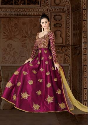Shine Bright At The Next Party You Visit In This Attractive Magenta Pink Colored Floor Length Dress Paired With Beige Colored Bottom And Dupatta. Its Top Is Fabricated On Art Silk Paired With Santoon Bottom And Net Dupatta. Its Heavy Embroidery Over the Yoke Is Making The Suit More Attractive.
