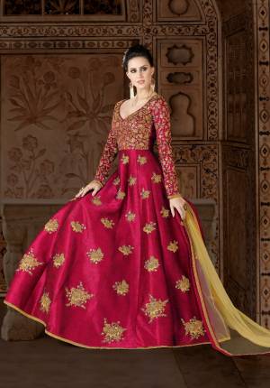 Shine Bright At The Next Party You Visit In This Attractive Dark Pink Colored Floor Length Dress Paired With Beige Colored Bottom And Dupatta. Its Top Is Fabricated On Art Silk Paired With Santoon Bottom And Net Dupatta. Its Heavy Embroidery Over the Yoke Is Making The Suit More Attractive.