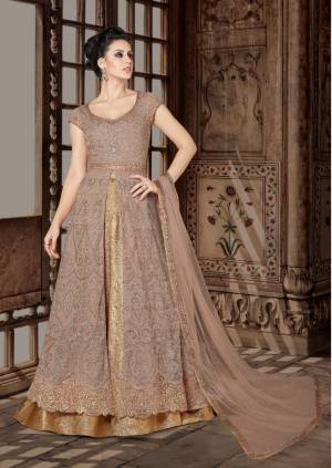 Look Pretty In This Pastel Brown Colored Designer Floor Length Suit. Its Top Is In Pastel Brown Color Paired With Beige colored Lehenga And Pastel Brown Colored Dupatta. Its Top Is Fabricated On Net Paired With Brocade Lehenga And Net Dupatta. Buy This Indo-Western Suit Now.