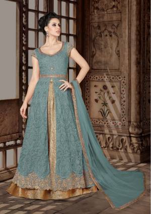 Look Pretty In This Steel Blue Colored Designer Floor Length Suit. Its Top Is In Steel Blue Color Paired With Beige colored Lehenga And Steel Blue Colored Dupatta. Its Top Is Fabricated On Net Paired With Brocade Lehenga And Net Dupatta. Buy This Indo-Western Suit Now.