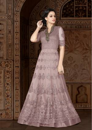 One Of The Favourite And Demanding Color Of The Season Is Here With The Beautiful Shade In Purple. Grab This Lovely Designer Floor Lentgh Suit In Mauve Color Paired With Mauve Colored Bottom And Dupatta. Its Top Is Fabricated On Net Paired With Santoon Bottom And Chiffon Dupatta. Its All Three Fabircs Ensures Superb Comfort All Day Long.