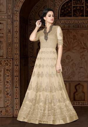 One Of The Favourite And Demanding Color Of The Season Is Here With The Beautiful Shade In Beige. Grab This Lovely Designer Floor Lentgh Suit In Beige Color Paired With Beige Colored Bottom And Dupatta. Its Top Is Fabricated On Net Paired With Santoon Bottom And Chiffon Dupatta. Its All Three Fabircs Ensures Superb Comfort All Day Long.