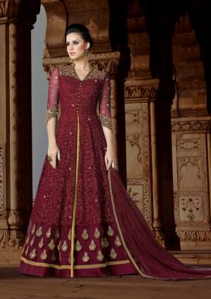 Celebrate This Festive Season With This Lovely Designer Floor Length Suit In Maroon Color Paired With Golden Colored Lehenga And Maroon Colored Dupatta. Its Top Is Fabricated On Net Paired With Art silk Lehenga And Net Dupatta. It Top Has Heavy Embroidery All Over It. Buy This Soon Before The Stock Ends.
