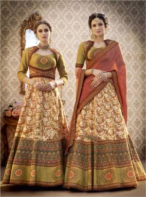 Grab This Beautiful Designer Lehenga Choli In Olive Green Colored Blouse Paired With Beige And Green Lehenga And Contrasting Pink Colored Dupatta. Its Blouse And Lehenga Are Fabricated On Banarasi Art Silk Paired With Chiffon Dupatta. This Lehenga Choli Can Also Be Stitched Into A Gown By Joining Yoke And Skirt. It Is Beautified With Digital Prints And Stone Work. Buy Now.