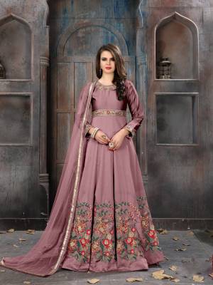 New And Unique Shade In Purple Is Here With This Designer Floor Length Suit In Mauve Colored Top Paired With Mauve Colored Bottom And Dupatta. Its Top Is Fabricated On Art Silk Paired With Santoon Bottom And Net Dupatta. It Is Beautified With Multi Colored Resham Embroidery And Stone Work. 