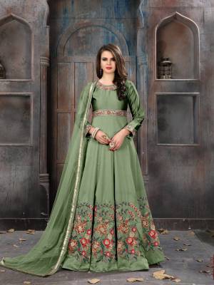 Grab This Beautiful Designer Floor Length Suit In Green Color Paired With Green Colored Bottom And Dupatta. Its Top Is Fabricated On Art Silk Paired With Santoon Bottom And Net Dupatta. Its Has Lovely Contrasting Embroidery With Resham Thread And Strone Work. Buy This Suit Now.