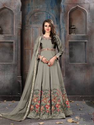 Flaunt Your Rich And Elegant Taste Wearing This Designer Floor Length Suit In Grey Color Paired With Grey Colored Bottom And Dupatta. Its Top Is Fabricated On Art Silk Paired With Santoon Bottom And Net Dupatta. Buy This Suit Now.