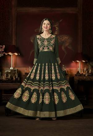 Appealing Shade In Green Is Here With This Designer Floor Length Suit In Pine Green Color Paired With Pine Green Colored Bottom And Dupatta. Its Top Is Fabricated On Georgette Paired With Santoon Bottom And Chiffon Dupatta. It Is Beautified With Contrasting Embroidery Over The Top. Buy Now.