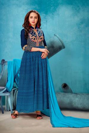 Be It Your Semi-Casual Wear Or Festive Wear, Grab This Designer Floor Length Suit In Navy Blue Colored Top Paired With Navy Blue Colored Bottom And Turquoise Blue Colored Dupatta. Its Top Is Fabricated On Georgette Paired With Santoon Bottom And Chiffon Dupatta. Its All Three Fabrics Ensures Superb Comfort All Day Long. 
