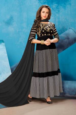 Enhance Your Beauty Wearing This Designer Floor Length Suit In Black And Grey Color Paired With Black Colored Bottom And Dupatta. Its Top Is Fabricated On Georgette Paired With Santoon Bottom And Chiffon Dupatta. It Is Beautified With Prints And Embroidery Which Will Earn You Lots Of Compliments From Onlookers.