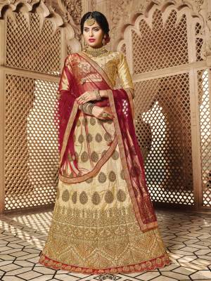 Flaunt Your Rich And Elegant Taste Wearing This Designer Lehenga Choli In Beige Color Paired With Maroon Colored Dupatta. This Royal Combination Will Earn You Lots Of Compliments From Onlookers. Its Blouse And Lehenga Are Fabricated On Art Silk Paired With Net Fabricated Dupatta. Buy Now.