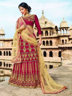 Adorn A Queen Like Look Wearing This Designer Lehenga Choli In Maroon Color Paired With Beige Colored Dupatta. Its Blouse And Lehenga Are Fabricated On Art Silk Paired With Net Fabricated Dupatta. It Is Beautified With Jari Embroidery All Over It.