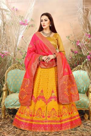 Celebrate This Festive Season Wearing This Lehenga Choli In Yellow Color Paired With Comtrasting Fuschia Pink Colored Blouse. This Lehenga Choli And Dupatta Are Fabricated On Jacquard Silk Beutified With Weave All Over.