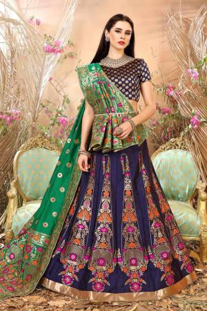 Enhance Your Personality Wearing This Lehenga Choli In Navy Blue Color Paired With Contrasting Green Colored Blouse. This Lehenga Choli And Dupatta Are Fabricated On Jacquard Silk Beautified With Weave. Buy This Lovely Piece Now.