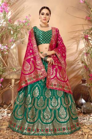 Add This Lovely Shade In Green With This Lehenga Choli In Pine Green Color Paired With Contrasting Dark Pink Colored Dupatta. Its Blouse, Lehenga And Dupatta Are Fabricated On Jacquard Silk Beautified With Weave. It Is Light Weight And Ensures Superb Comfort All Day Long.